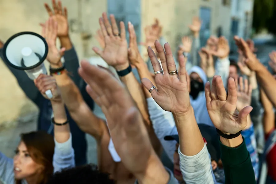 closeup-crowd-protesters-with-arms-raised-demonstrating-streets.jpg